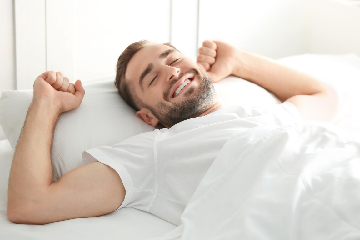 Man Lying in Bed at Home